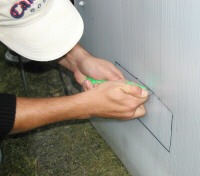 Tracing the rectangle for cutting the hole in the greenhouse panel