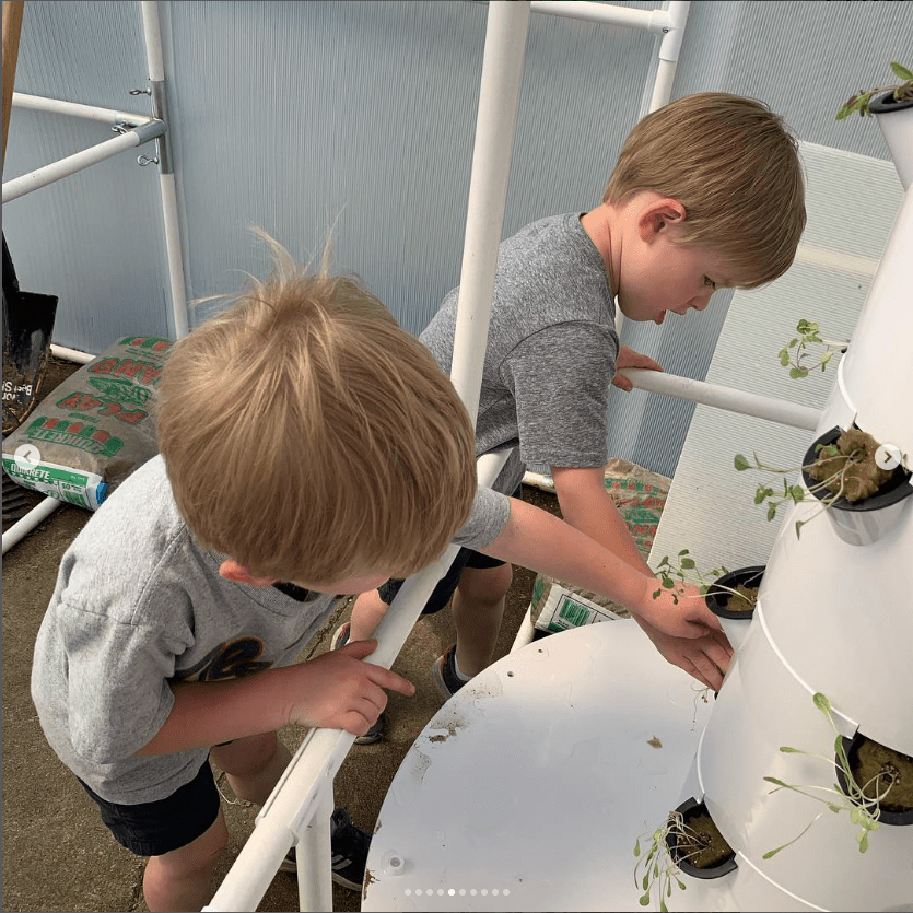 Kids gardening in school greenhouse